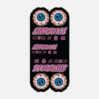 Black skateboard deck with colorful eye designs and 'Slime Balls' branding on a white background
